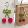Handmade cherry keychain with green ribbon and pink cherries